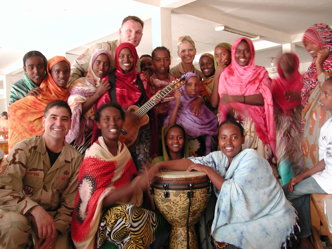 Night Wing, of the USAF Heartland of America Band, had the rare opportunity to visit and perform at an orphanage in Djibouti, Africa.  Pictured with their new friends are Master Sergeant Doug Montera, Master Sergeant Jimmy Weber and Staff Sergeant Lara Murdzia. 