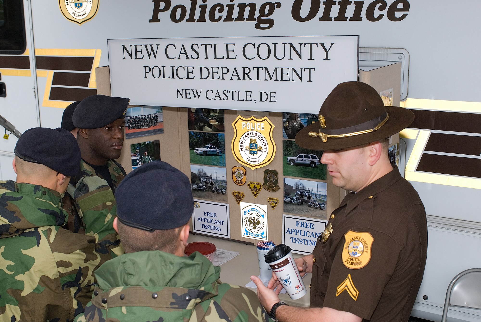 DOVER AIR FORCE BASE, Del. -- Steven Donahue, New Castle County Police Department, talks about the benefits of being an officer with a group of 436th SFS Airmen. During Police Week here, law enforcement agencies got a chance to compare their jobs and equipment with security forces and one another. (U.S. Air Force photo by Roland Balik)