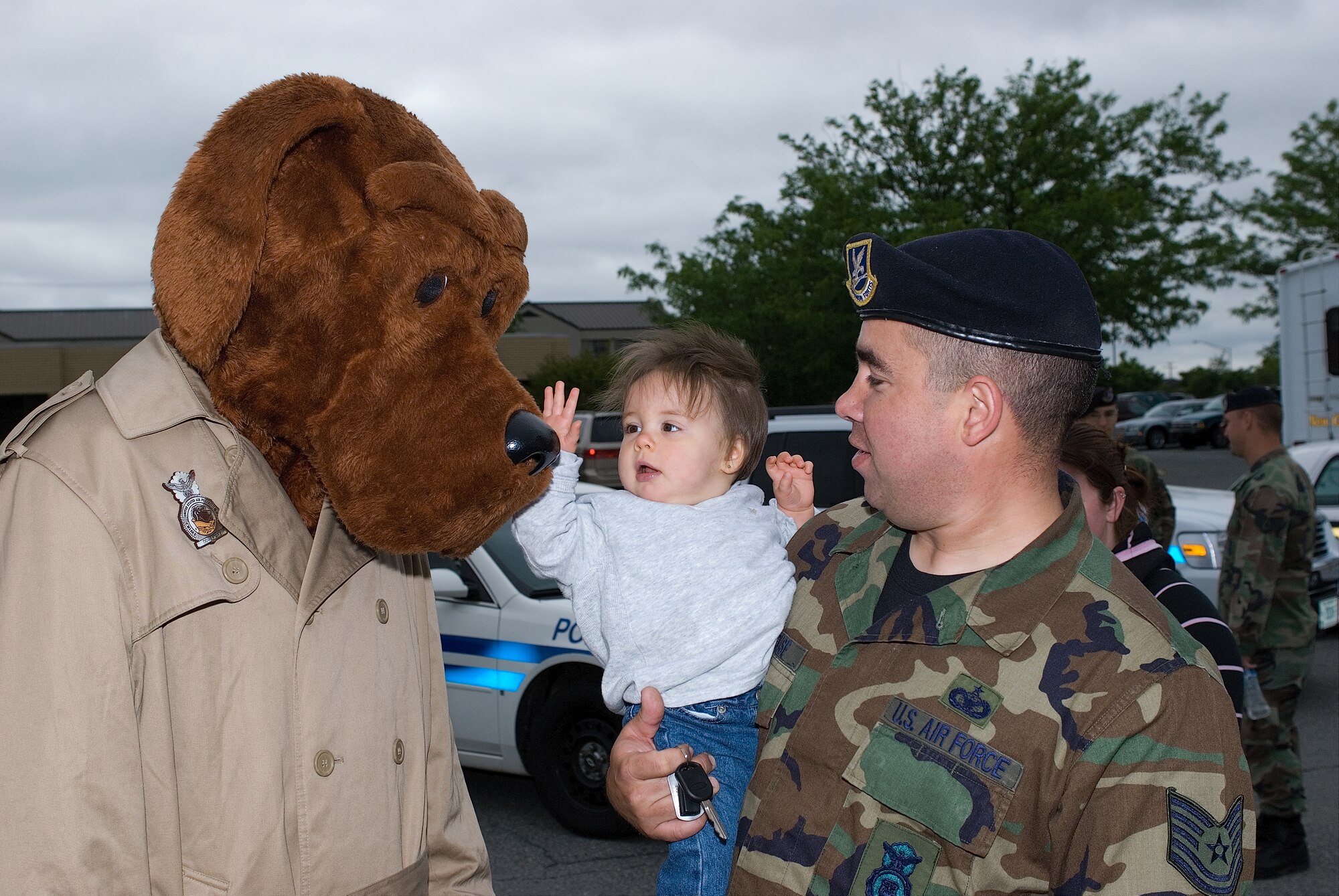 DOVER AIR FORCE BASE, Del, -- Tech. Sgt. Edward Strouse, 436th Security Forces Squadron, holds his 9-month-old daughter, Zowie, as she pets McGruff the Crime Dog. Dover Air Force Base held Police Week activities May 18 to commemorate the officers who have died in the line of duty. Sergeant Strouse was the assistant coordinator for activities during Police Week. (U.S. Air Force photo/Roland Balik)