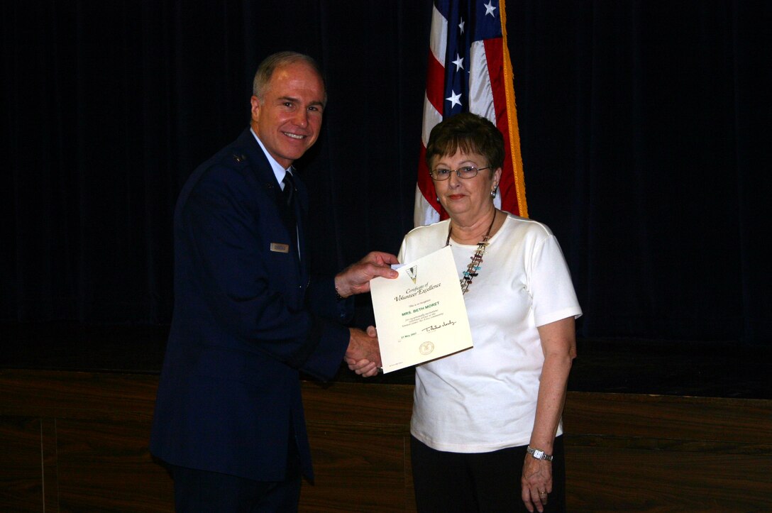 Beth Moret accepts an Air Force Volunteer Excellence Award from 82nd Training Wing Commander Brig. Gen. Richard Devereaux.  Mrs. Moret tied with her competition, Angie Reth, for the lifetime achievement award. (U.S. Air Force photo/Staff Sgt. Tonnette Thompson)