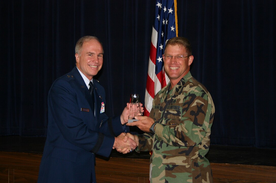 82nd Mission Support Group Deputy Commander Lt. Col. Curt Van De Walle accepts a Volunteer of the Year award from 82nd Training Wing Commander Brig. Gen. Richard Devereaux, on behalf of 1st Lt. Sabrina Sparkman, 82nd MSG.  Lieutenant Sparkman won in the company grade officer category for her work with the Wichita Falls Children's Shelter, Meals on Wheels, Give a Child a Christmas, and service at her church. (U.S. Air Force photo/Staff Sgt. Tonnette Thompson)