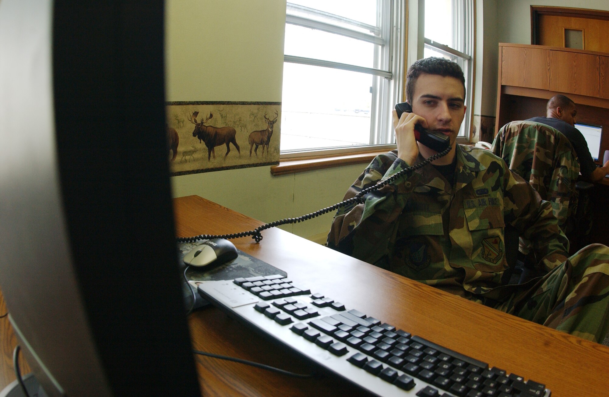 EIELSON AIR FORCE BASE, Alaska -- Senior Airman Joseph Achnitz, 354th Communications Squadron net admin, helps troubleshoot a problem for a customer May 22 at the network control center here at Eielson AFB, AK. The NCC is responsible for more than 2,200 computers on base making sure all are up to date with patches, standard desktop configuration complaint, and ensure day to day mission success. (U.S. Air Force Photo by Airman 1st Class Jonathan Snyder)
