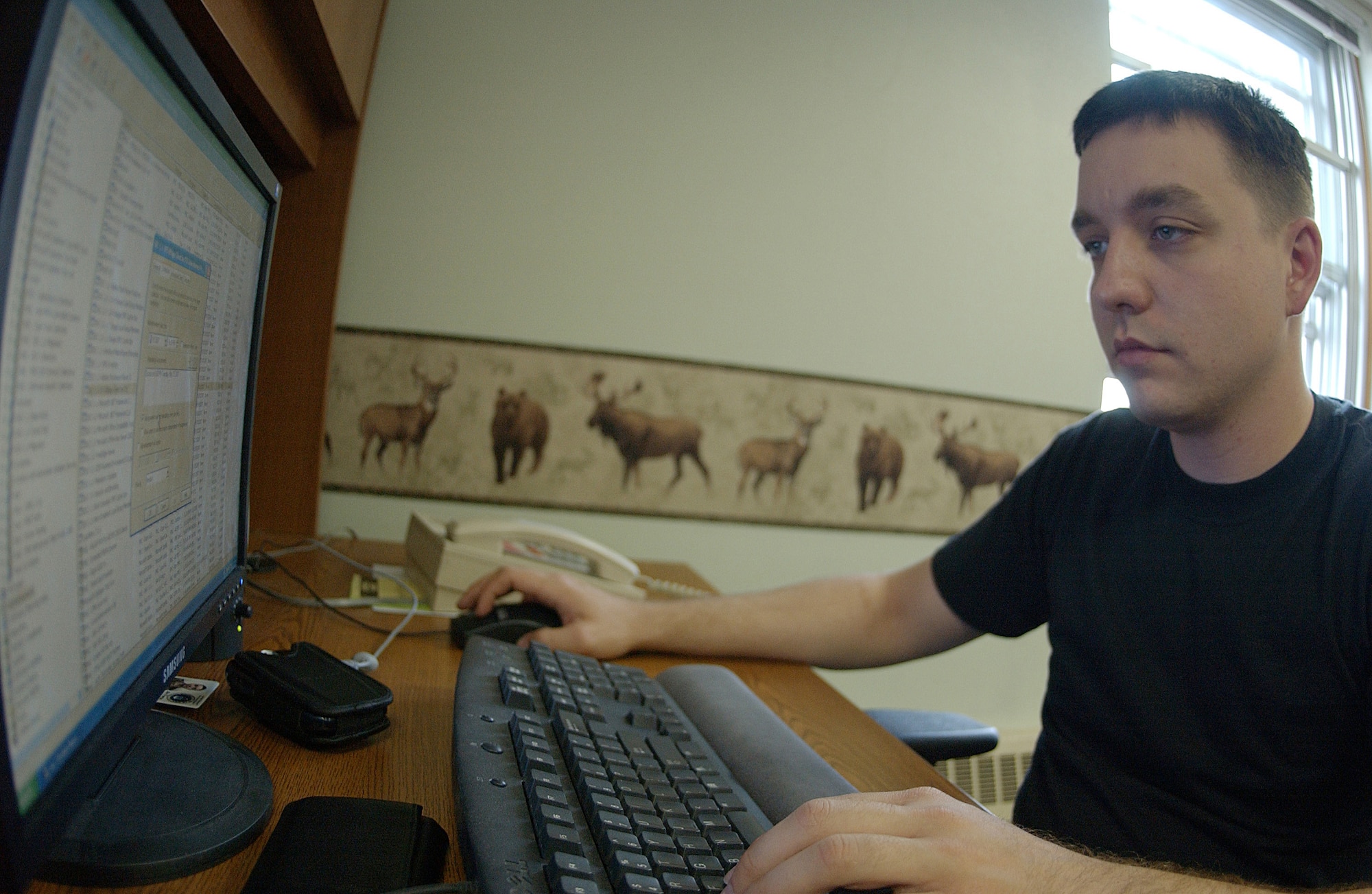 EIELSON AIR FORCE BASE, Alaska -- Senior Airman Drew Bartlett, 354th Communications Squadron net admin, uses system management server program which applies patches through the network to every computer on base May 22 at the network control center here at Eielson AFB, AK. The NCC is responsible for more than 2,200 computers on base making sure all are up to date with patches, standard desktop configuration complaint, and ensure day to day mission success. (U.S. Air Force Photo by Airman 1st Class Jonathan Snyder) 