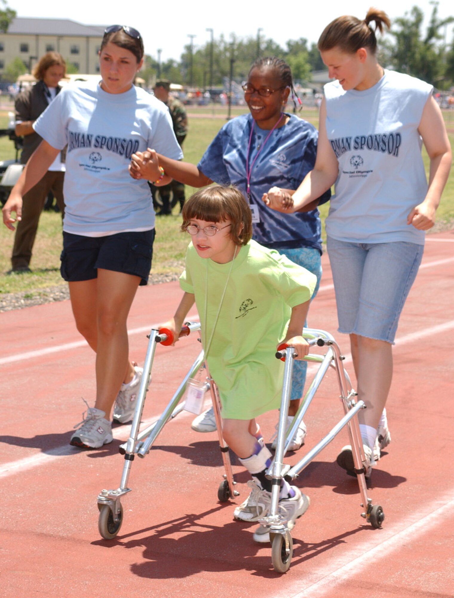 Rachel Cato leads, from left, Laura Donaldson, 334th Training Squadron, Shawn Chocolate and Caitlin Kettle, 334th TRS, down the track during the 25-meter assisted walk.   (U. S. Air Force Photo by Kemberly Groue)