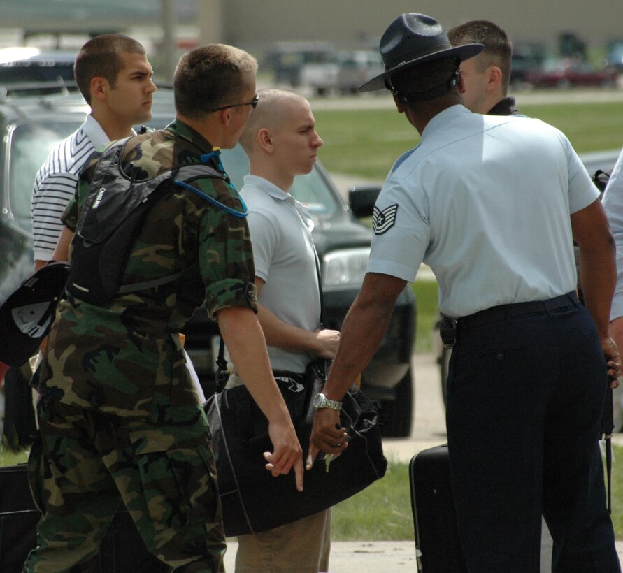 Tech. Sgt. Anthony Brown, military training instructor,  along with the help of Cadet Training Assistant , directs Reserve Officer Training Corps cadets to where they should be standing. Sergeant Brown, here from Lackland Air Force Base, Texas, will assist cadets to complete the only congressionally-mandated portion of their training. As the first of three ROTC encampments, this group will be at Ellsworth May 24 through June 21. (U.S. Air Force photo/Airman 1st Class Kimberly Moore Limrick)
