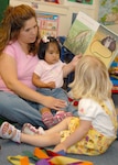 Criscinda Rivera, Randolph Family Child Care provider, reads to children at her home May 22. Ms. Rivera was named FCC Provider of the Year for the second consecutive year.  (U.S. Air Force photo by Rich McFadden) 