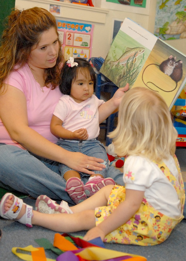 Criscinda Rivera, Randolph Family Child Care provider, reads to children at her home May 22. Ms. Rivera was named FCC Provider of the Year for the second consecutive year.  (U.S. Air Force photo by Rich McFadden) 