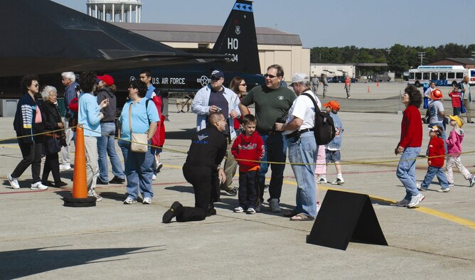 Tech. Sgt. Nathan Knox, F-117 Demonstration Team superintendent, shares information about the Nighthawk with a family during the Joint Services Open House, held at Andrews Air Force Base, Md., May 18-20. (U.S. Air Force photo by 1st Lt. Phil Ventura) 
