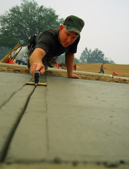 MOODY AIR FORCE BASE, Ga, --  Staff Sgt. Matthew Bell, 23rd Civil Engineer Squadron pavements and construction equipment craftsman, creates a seam in a new sidewalk May 22, in front of Moody’s new Consolidated Base Support Center. The $9.6 million facility is scheduled to be completed this summer. (U.S. Air Force photo by Tech. Sgt. Parker Gyokeres)