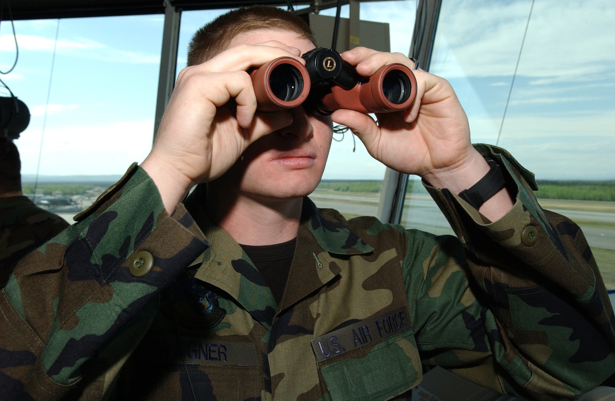 EIELSON AIR FORCE BASE, Alaska -- Airman First Class Kenneth Wagner, 354th Operations Support Squadron air traffic controller, checks for planes coming down the flight line May 23 here. Airman Wagner is in charge of ground data which deals with all planes currently on the ground on the flightline and all actions of the aircraft are closely monitored by him.  (U.S. Air Force photo by Airman 1st Class Christopher Griffin)
