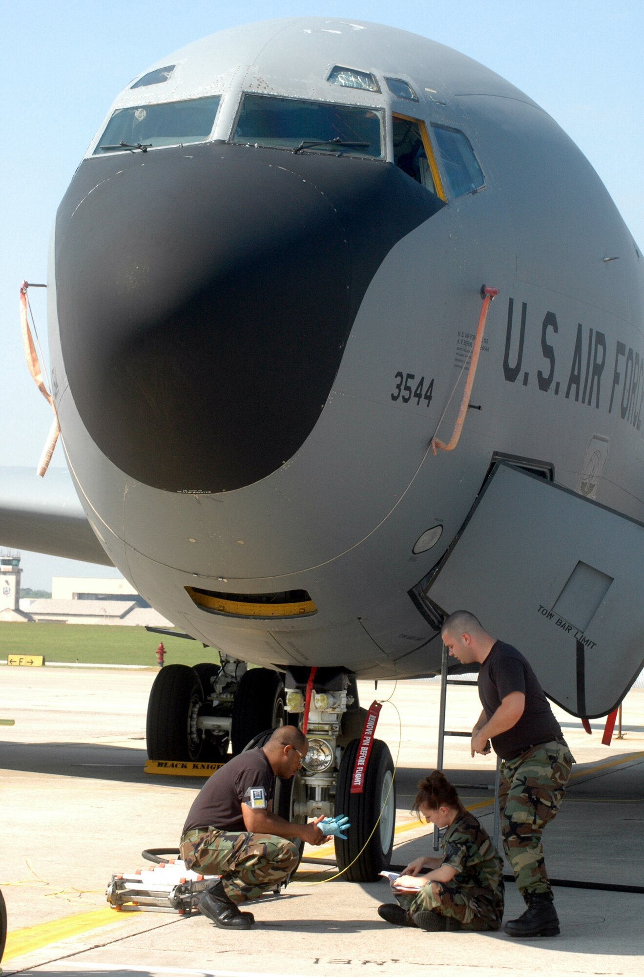 Members of the 19th AMXS work beneath a KC-135. U. S. Air Force photo by Sue Sapp  