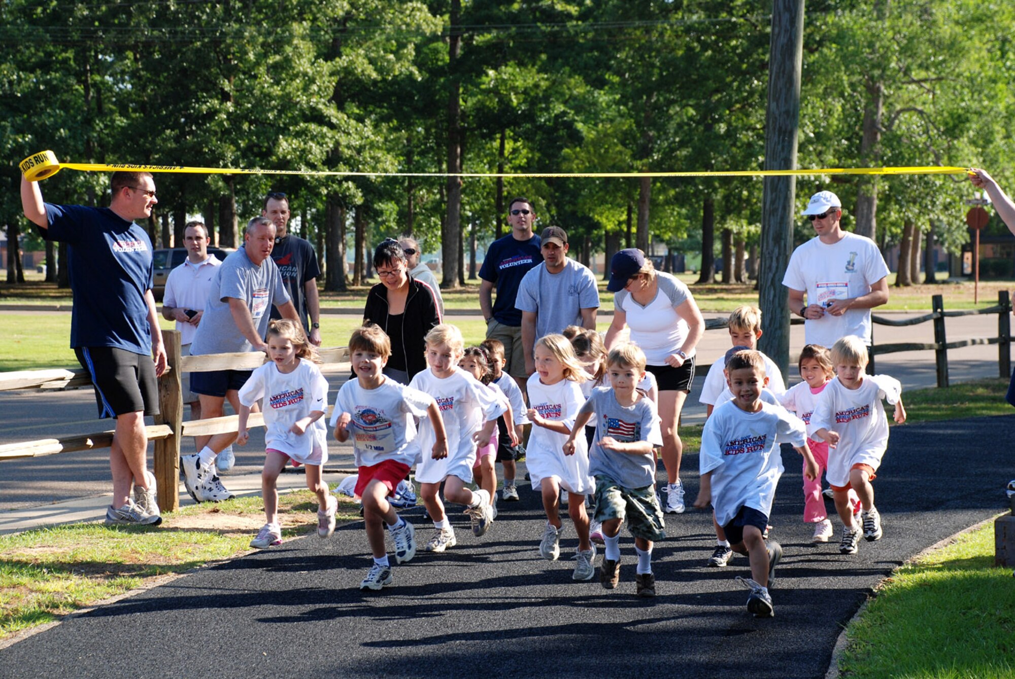 Youth, ages five and six, take off  at the start of the Annual America’s Kids Run Saturday at the track. (U.S. Air Force Photo)