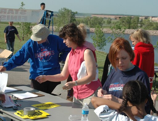 Parents register their children for the Americans Kids Run event held at the Heritage Lake track May 19. More than 30 children participated in this years event. (U.S. Air Force photo/Tech. Sgt. Todd Wivell)
