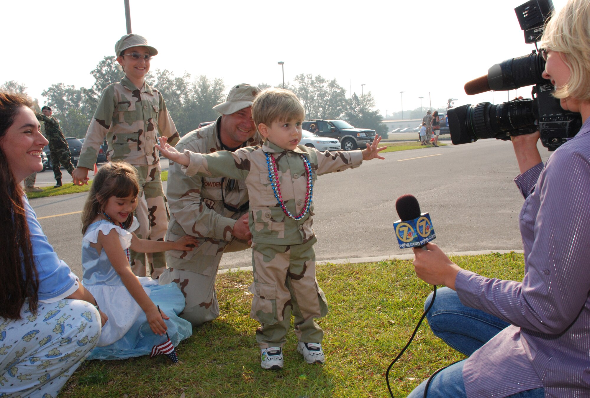 EGLIN AIR FORCE BASE, Fla. -- Ian Bowden, 2, spreads his as wide as he can to illustrate to a local news reporter how big the fish his dad, Maj. Cooper Bowden, is going to catch on their upcoming fishing trip during the homecoming celebration May 24 for the 728th Air Control Squadron. Family members gathered in front of the squadron as more than 175 members of the 728th ACS, the Demons, returned home from a deployment to Southwest Asia in support of Operation Iraqi Freedom. The 728th ACS mission encompasses the widest variety of Air Force careers, affording it global reach and the ability to complete its mission anywhere needed. The Airmen spent the last five months in Iraq controlling and monitoring Iraqi airspace, assisting in providing close air support for troops in conflict and reconnaissance and directing tanker traffic for refueling efforts. The squadron has spent nine of the past 12 months deployed. (U.S. Air Force photo by Staff Sgt. Mike Meares)