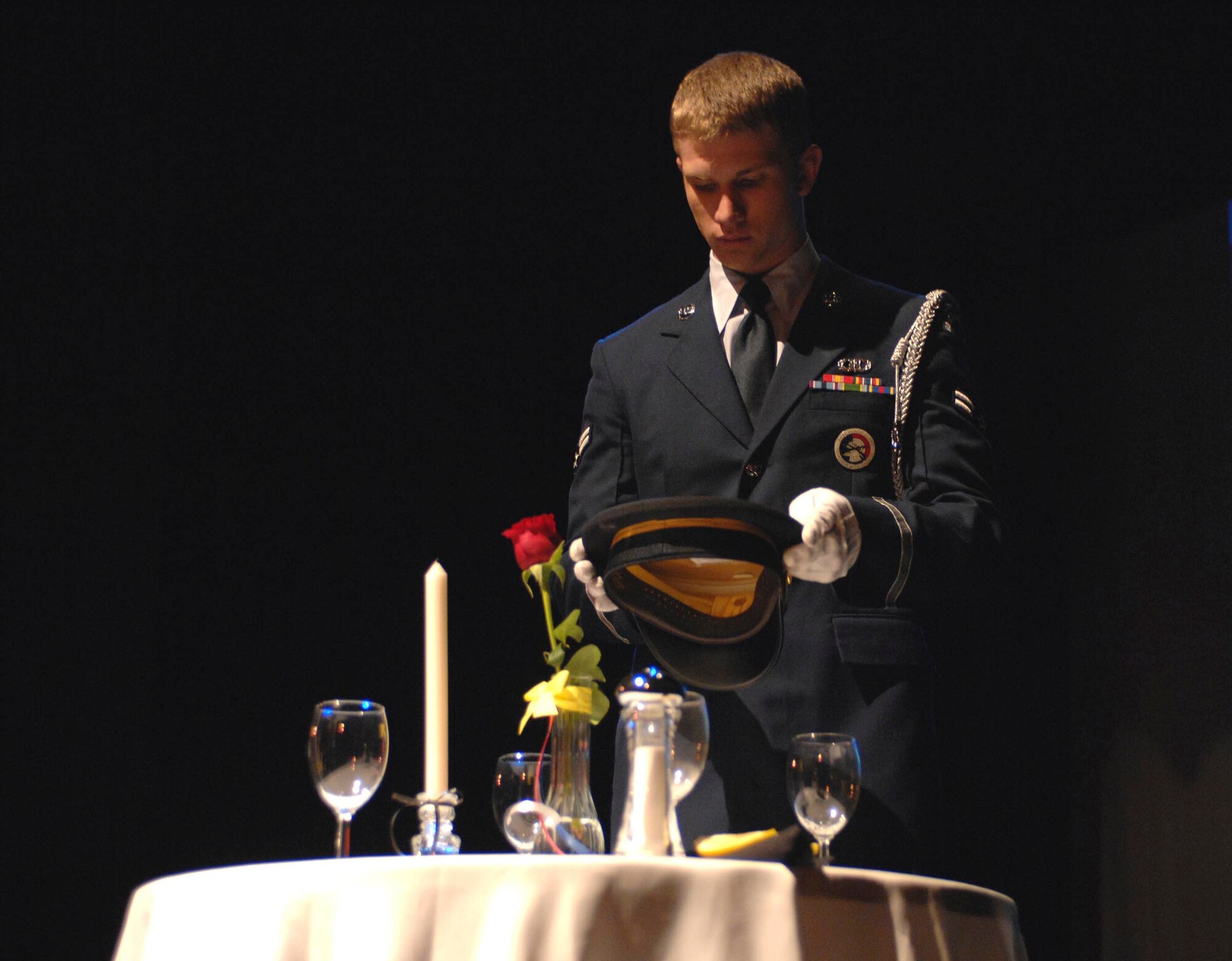 SUMTER, S.C. -- Airman First Class Zach Ritsema, 20th Fighter Wing Honor Guard member, places the U.S. Army hat on the prisoner of war missing in action table during a memorial service held at the Sumter Opera House May 23. The memorial service, which served as a kick off to the upcoming Memorial Day weekend, was hosted by Shaw Air Force Base, S.C. and the Sumter community. (U.S. Air Force photo by Tech. Sgt. Keri Whitehead)