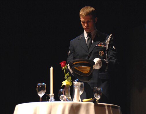 SUMTER, S.C. -- Airman First Class Zach Ritsema, 20th Fighter Wing Honor Guard member, places the U.S. Army hat on the prisoner of war missing in action table during a memorial service held at the Sumter Opera House May 23. The memorial service, which served as a kick off to the upcoming Memorial Day weekend, was hosted by Shaw Air Force Base, S.C. and the Sumter community. (U.S. Air Force photo by Tech. Sgt. Keri Whitehead)