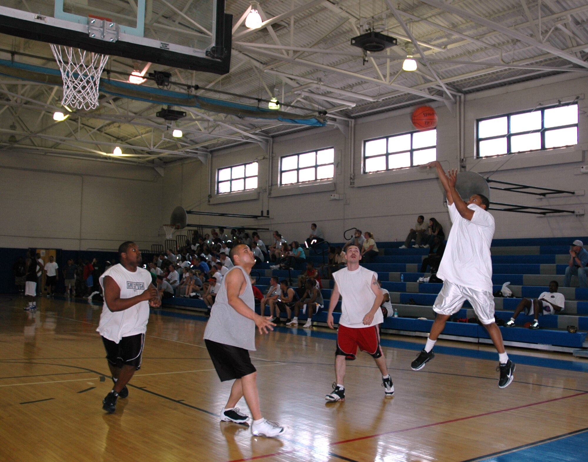 DOVER AIR FORCE BASE, Del. -- Staff Sgt. Rayshard Jones, 512th Operations Group, shoots a jumpshot during a game against the 436th Aerial Port Squadron as part of the base's Sports Day May 2. The 512th OG basketball team made it to the championship game but fell three points short of the title. Other Sports Day competitions included golf, softball and running. In all, the Liberty Wing ranked 7th out of 18 teams. (U.S. Air Force photo/Veronica Morris)