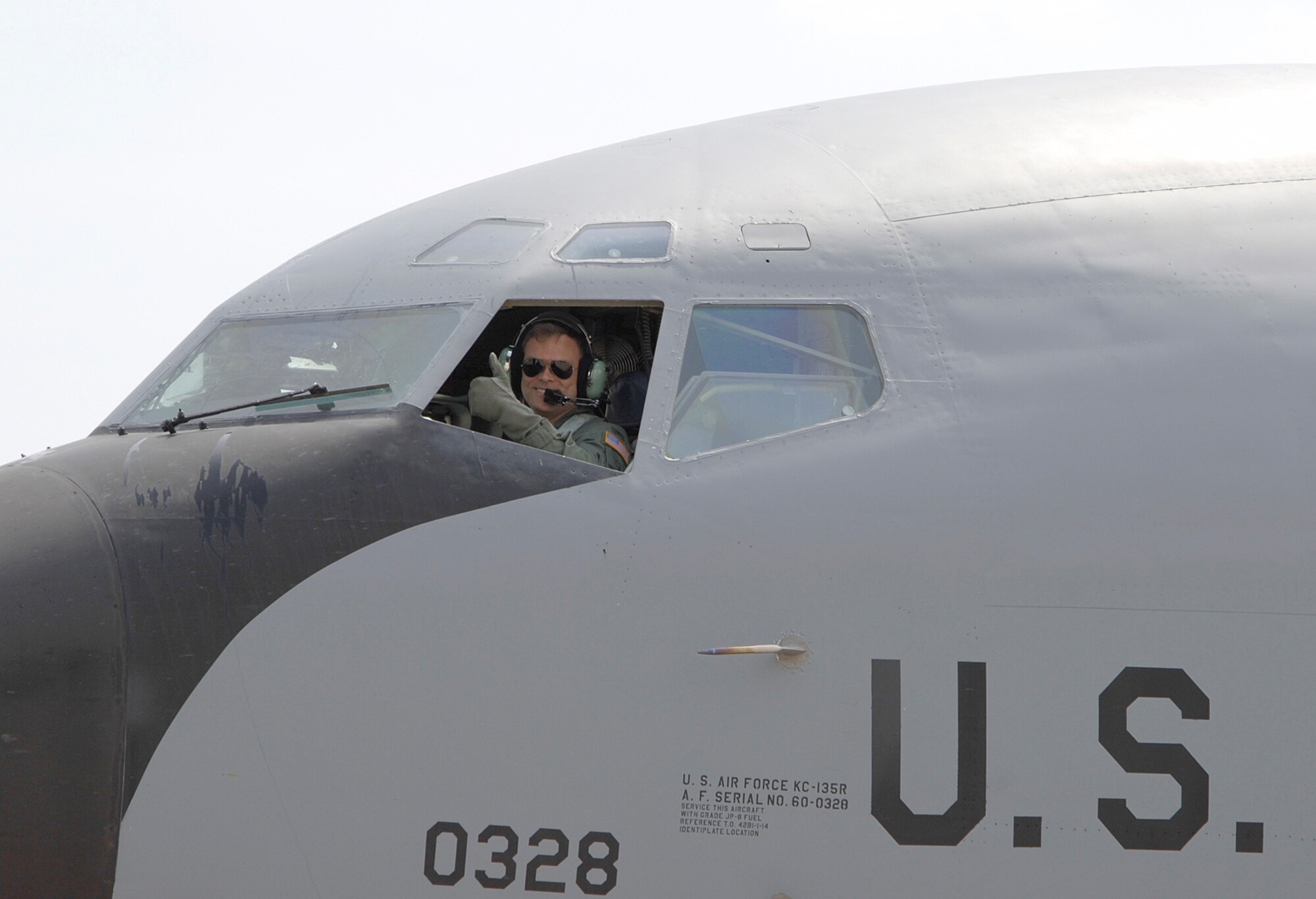 Col. T. Harrison Smith, Jr., 22nd Air Refueling Wing vice commander, gives a “thumbs-up” as he takes his final flight at McConnell flying a KC-135 Stratotanker. During his 23 years of service, he spent more than one year at McConnell and will serve his next assignment as commander of the 376th Air Expeditionary Wing, Manas Air Force Base, Kyrgyzstan. (Photo by Airman 1st Class Jamie Train)