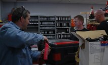 James Laffen, a 419th Fighter Wing crew chief, turns in tools to Staff Sgt. Ryan Mount, 34th Aircraft Maintenance Squadron support technician, following an aircraft launch May 23.  The active duty and Reserve fighter wings at Hill began sharing equipment as early as February 2006 as part of Total Force Integration initiatives. (U.S. Air Force photo by 2nd Lt. Beth Woodward)