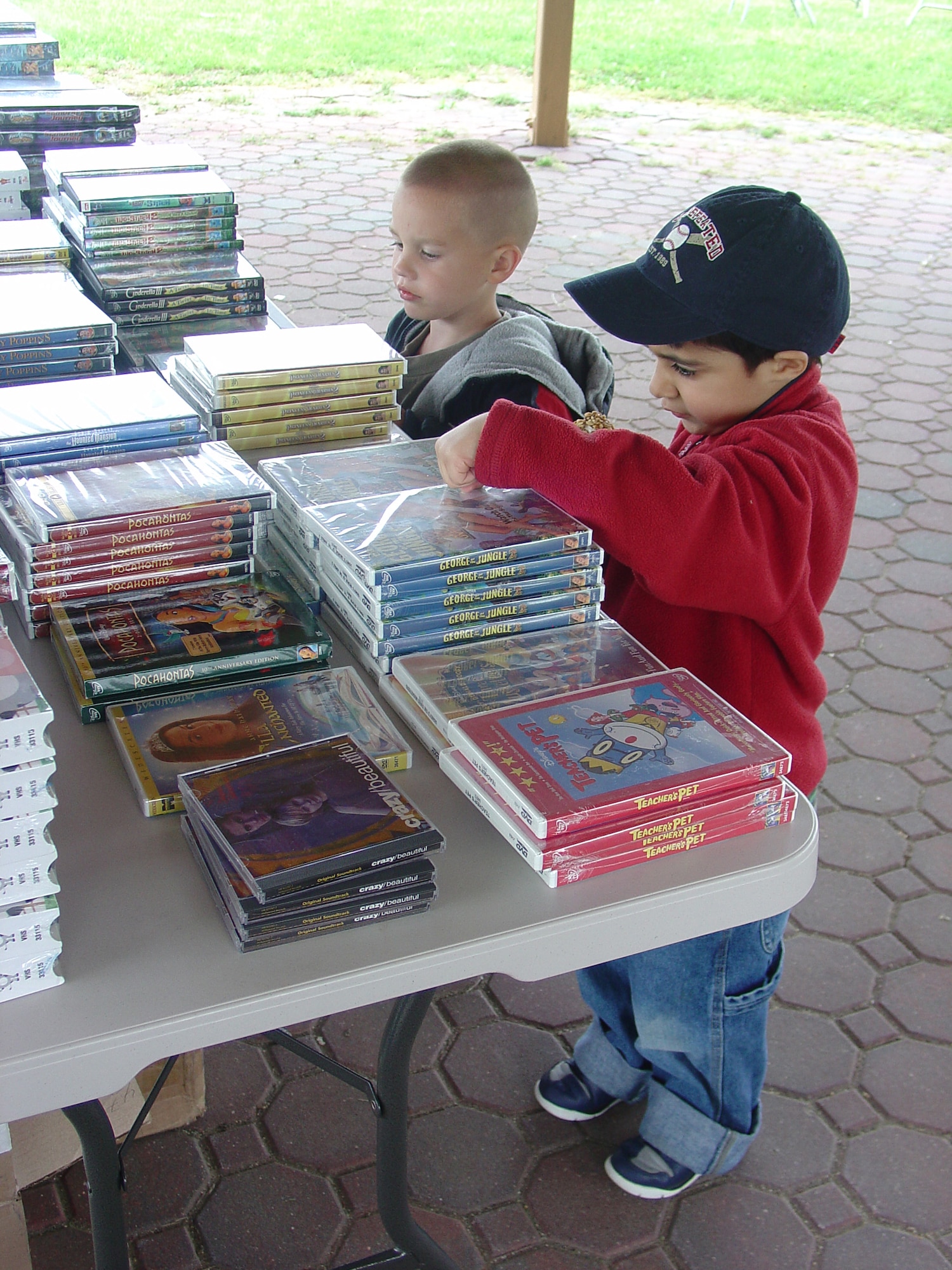 Right, Eddy Lopez, and Peyton Jensen, both 4, pick out two DVDs each at the United Services Organization Military Appreciation barbecue/movie event here Saturday. Families enjoyed a barbecue lunch and a complimentary showing of “Meet the Robinsons” at the base theater.