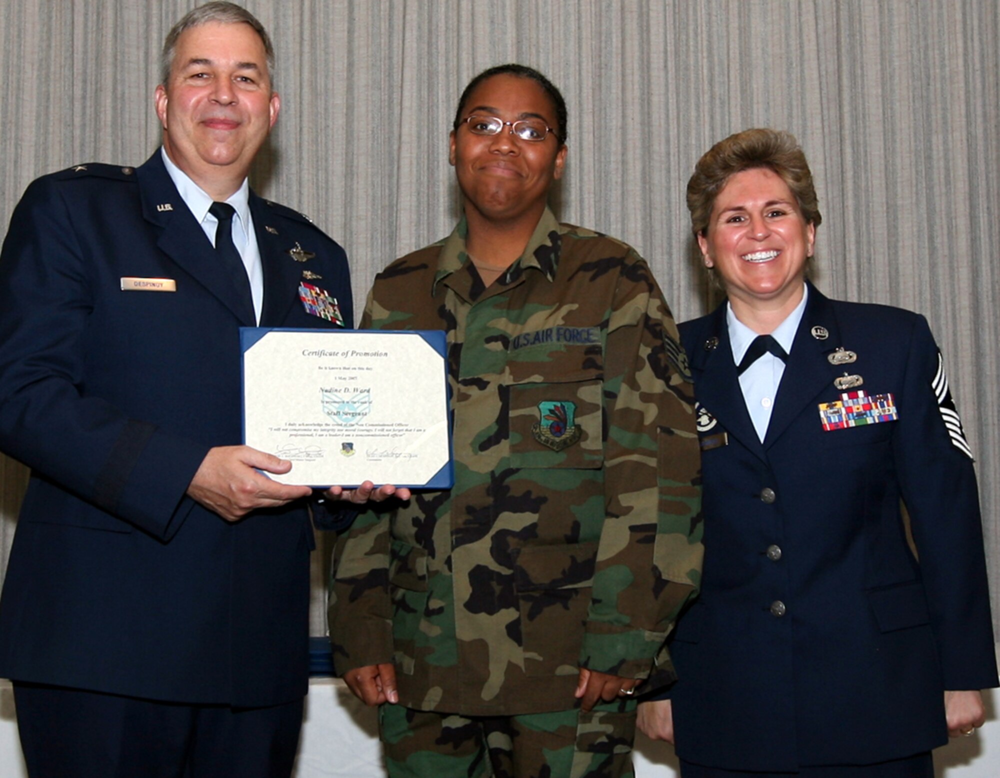 GRISSOM AIR RESERVE BASE, Ind., -- Air Force Reservist Nadine Ward, center, is promoted to the rank of staff sergeant by Brig. Gen. Dean Despinoy, 434th Air Refueling Wing commander, left, and Chief Master Sgt. Peri Rogowski, command chief, during a special ceremony recently. (U.S. Air Force photo/SrA. Omar DelaCruz)