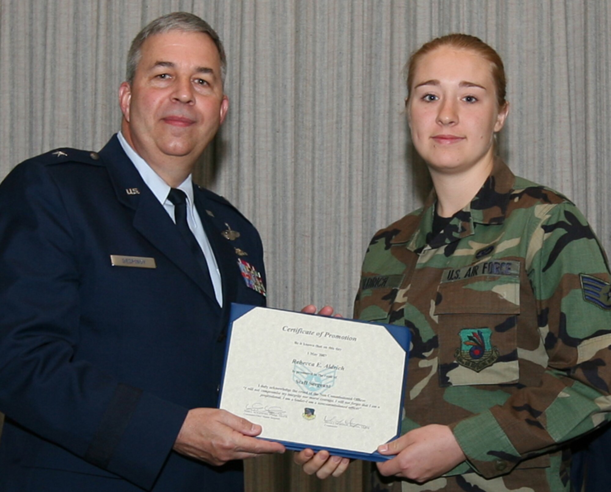 GRISSOM AIR RESERVE BASE, Ind., -- Air Force Reservist Rebecca Aldrich is promoted to the rank of staff sergeant by Brig. Gen. Dean Despinoy, 434th Air Refueling Wing commander, left, during a special ceremony recently. (U.S. Air Force photo/SrA. Omar DelaCruz)