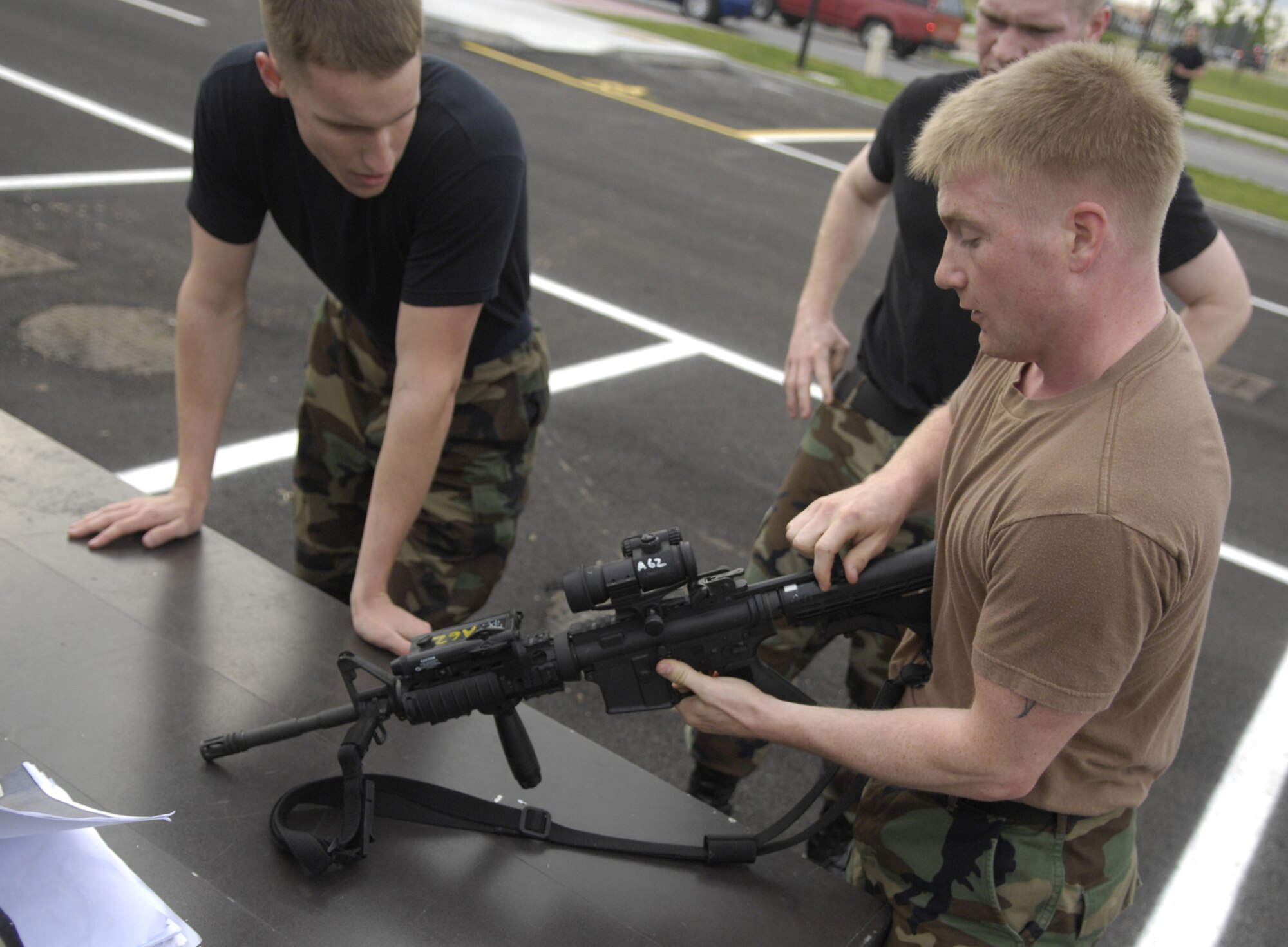 Senior Airman Paul Kalle, left, watches as Senior Airman Cody Schultz performs a function check on the M-4 during the 31st Security Forces Squadron combat run for National Police Week May 15. Security forces Airmen competed in a race challenging their minds and capabilities. They performed weapons functions checks, tested their duty knowledge and competed in a run. (U.S. Air Force photo by Airman 1st Class Michael Dorus)