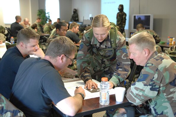 SHAW AIR FORCE BASE, S.C. -- Staff Sgt. Jessica Feil, 20th Civil Engineer Squadron Readiness Logistics NCOIC, teaches members of CES land navigation while participating in a field training exercise May 23. As part of the four-day FTX the 20th CES trained in self-aid buddy care, cardiopulmonary resuscitation, weapons safety, decontamination, security, land navigation, night operations and any job-specific training required. (U.S. Air Force photo by Airman First Class Kathrine McDowell)
