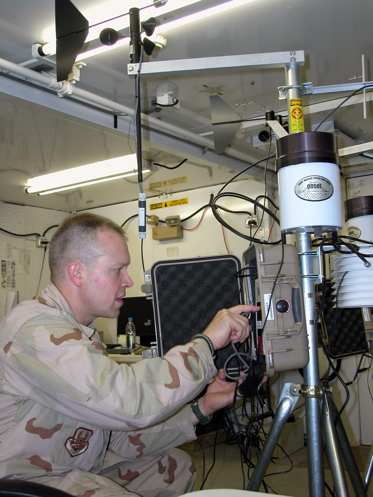 Maj. Thomas Shaak makes adjustments to a Global Integrated Monitoring System May 11 at Balad Air Base, Iraq. The system puts a global viewer on the desktop of commanders providing them situational awareness for the real world and assisting them in documenting and protecting their people from chemical exposures. Major Shaak is assigned to the 332nd Expeditionary Medical Group's biological augmentation team.  (U.S. Air Force photo/Master Sgt. Bryan Ripple) 