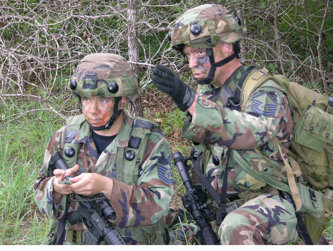Two members of the 916th Security Forces Squadron successfully navigate the terrain while participating in mandatory pre-deployment training. 'Patriot Defender' training was held at Camp Swift near Austin, Texas. The 916th SFS will be deployed to Iraq later this year. (U.S. Air Force Photo/Staff Sgt. Scott Mathews)                   