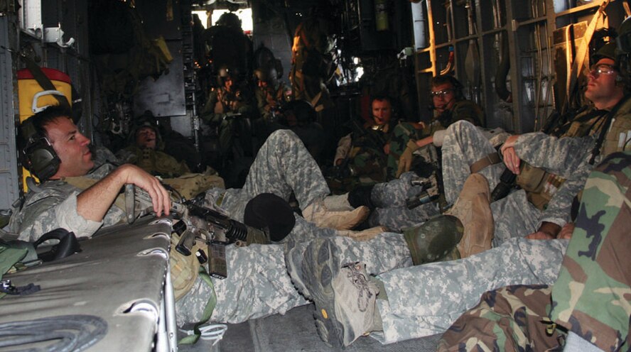 Airmen from the 20th Special Operations Squadron and Soldiers from Army Special Forces stretch out in the back of an MH-53 PAVE LOW during the Special Operations Forces Exercise May 15. The 20th SOS was one of many squadrons to participate in the exercise which incorporated AC-130s, MC-130Ps, MH-53s, CV-22s and the MQ-1 aircraft. (U.S. Air Force photo by 2nd Lt. Lauren Johnson)