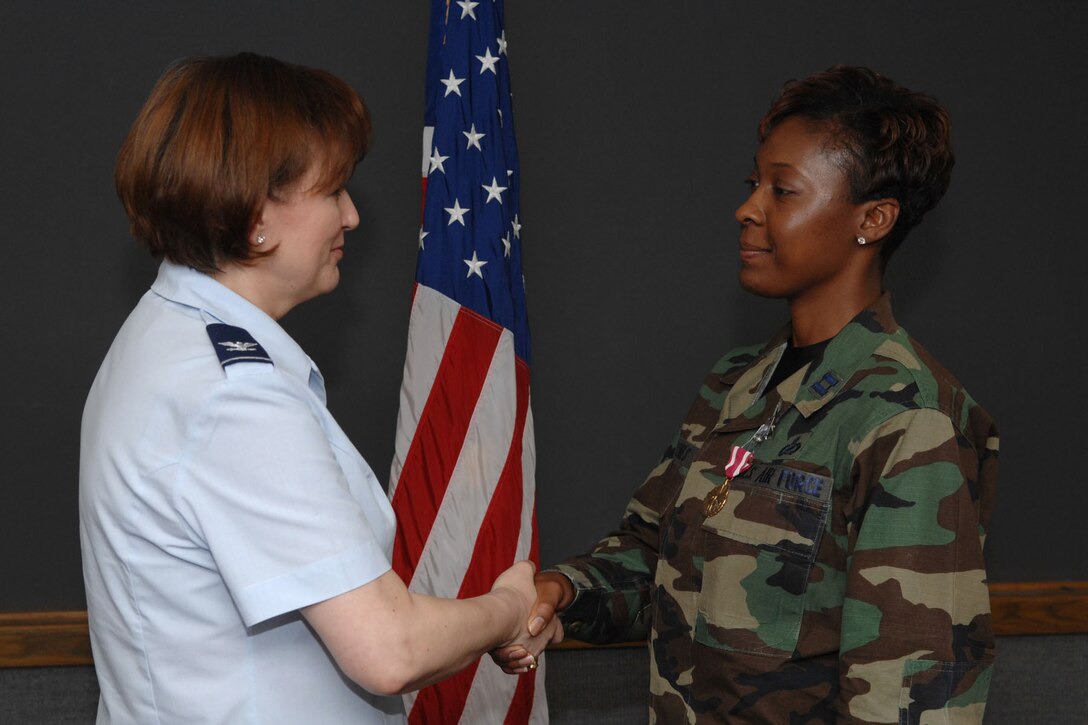 Colonel Susan Strednansky, HQ USAFE Director of Public Affairs (PA), presents Captain Toni J. Tones with a Meritorious Service Medal for her accomplishments while assigned to HQ USAFE Public Affairs Office, 1 Oct 03 - 1 Jun 07.
