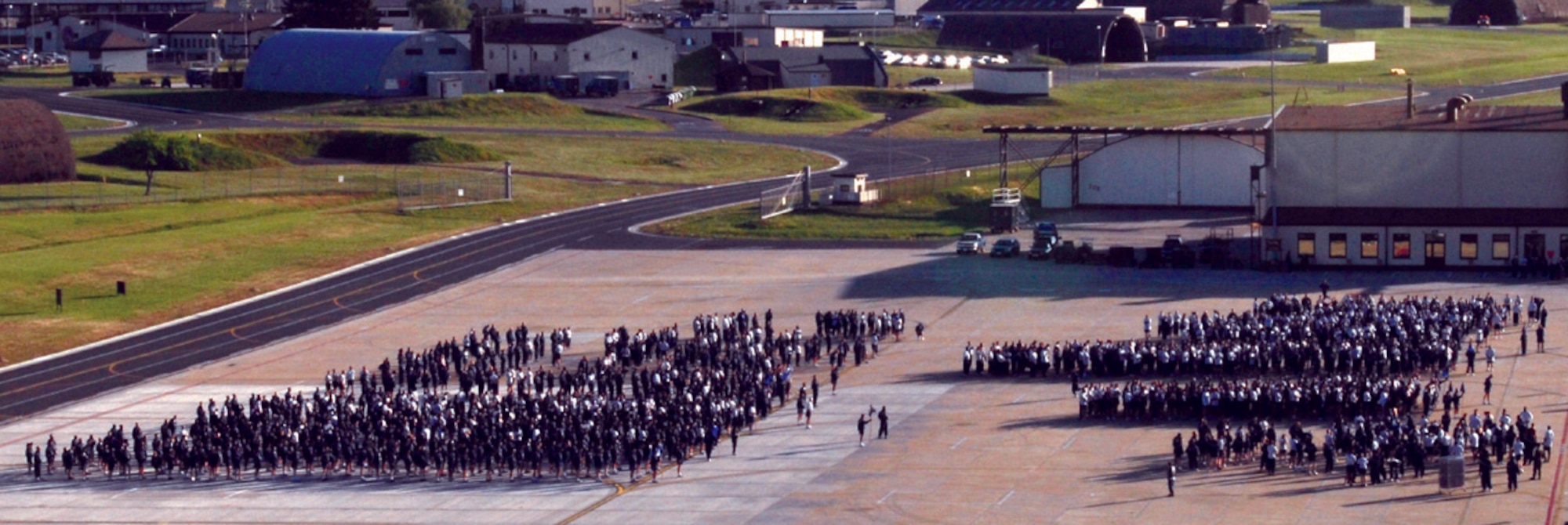 SPANGDAHLEM AIR BASE, GERMANY -- A tower view shows approximately 2,000 Airmen, and a handful of Soldiers, warming up the 52nd Fighter Wing fun run May 1. The group of runners ran about two miles on Spangdahlem’s runway. The runners ran with their respective groups and units to show unit and mission pride. (US Air Force photo/Airman 1st Class Emily Moore)