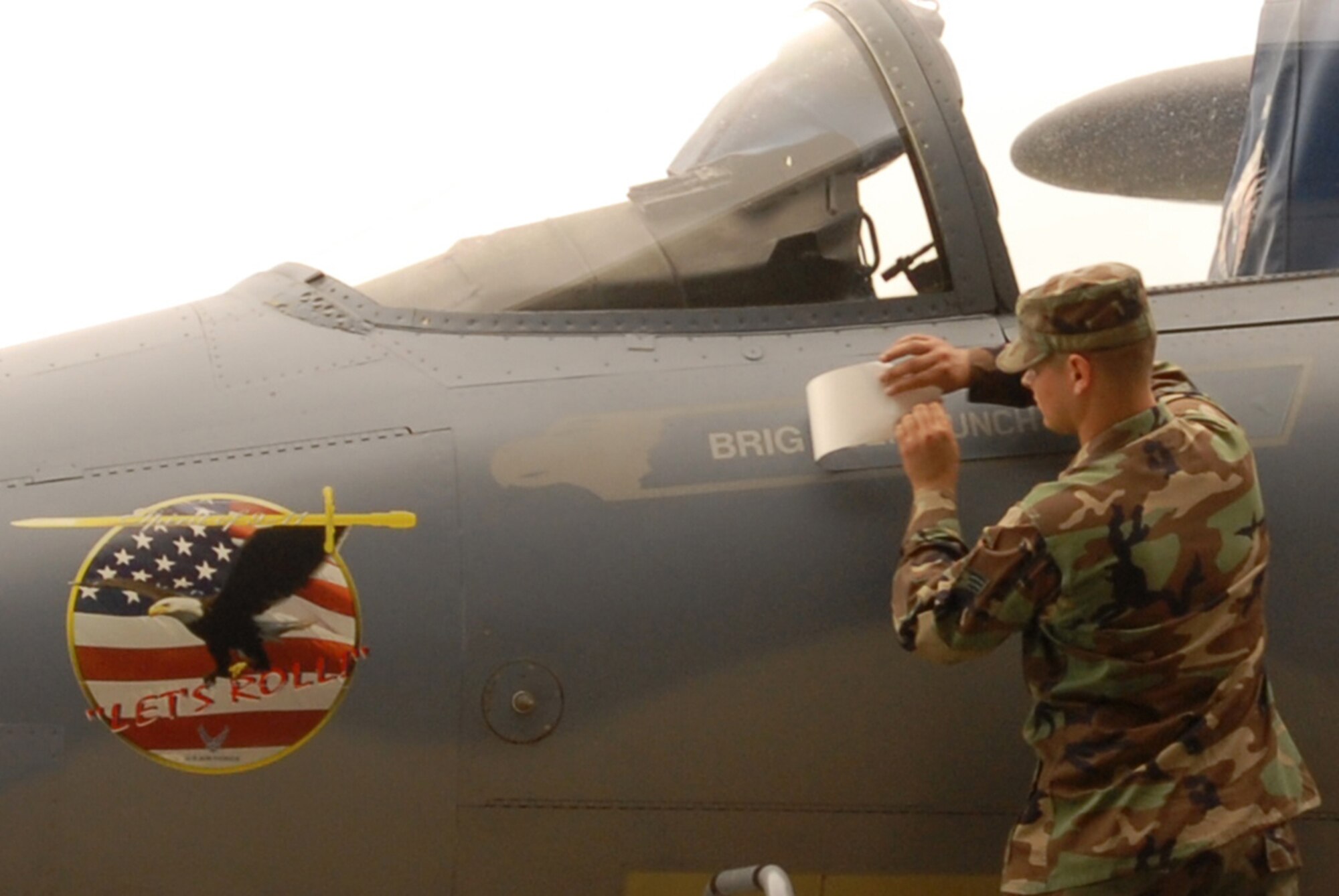 Senior Airman Nicholas Durham, 18th Air Maintenance Squadron, removes Brig. Gen. Moulton’s name from an F-15C Eagle aircraft to reveal Brig. Gen. Brett Williams’ name during the 18th Wing change of command ceremony at Kadena Air Base, Okinawa, May 24. General Williams assumed command of the wing during the ceremony.
(U.S. Air Force/Airman 1st Class Kasey Zickmund)