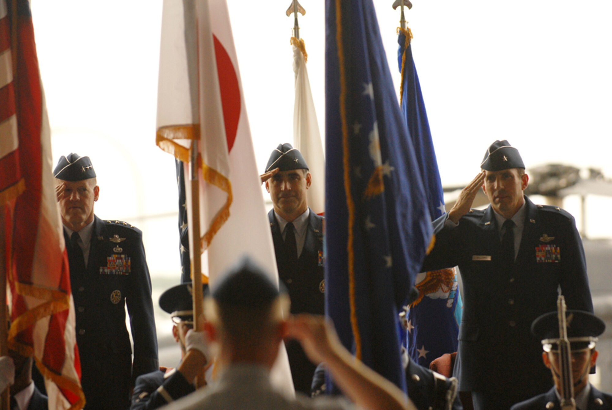 Col. Jeffrey Kennedy (foreground), 18 Wing vice commander, salutes the colors at the beginning of the change of command ceremony May 24 at Kadena AB, Okinawa. Lt. Gen. Bruce Wright, U.S. Forces Japan commander; Brig. Gen. Punch Moulton and Brig. Gen. Brett Williams are in the background. General Moulton relinquished command of the 18th Wing to General Williams during the ceremony. 
(U.S. Air Force/Staff Sgt. Reynaldo Ramon)