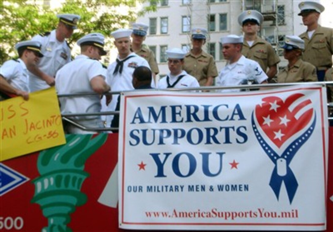 Marines and sailors stand atop a double-decker bus that bears the America Supports You banner, outside the CBS studios in New York City, May 24, 2007. CBS's "The Early Show" featured the America Supports You program. 