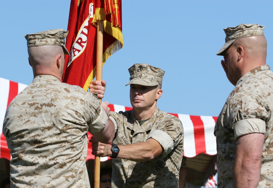 Lt. Col. Kenneth M. DeTreux (left) hands Lt. Col. Jay M. Bargeron the battalion colors during the change of command ceremony for 2nd Battalion, 8th Marine Regiment, 2nd Marine Division, here, May 24. The transfer of the colors during the ceremony signified the relinquishing of responsibility, accountability and authority of the outgoing commander as the incoming commander confirmed his total dedication to the Marines and sailors of his new command.