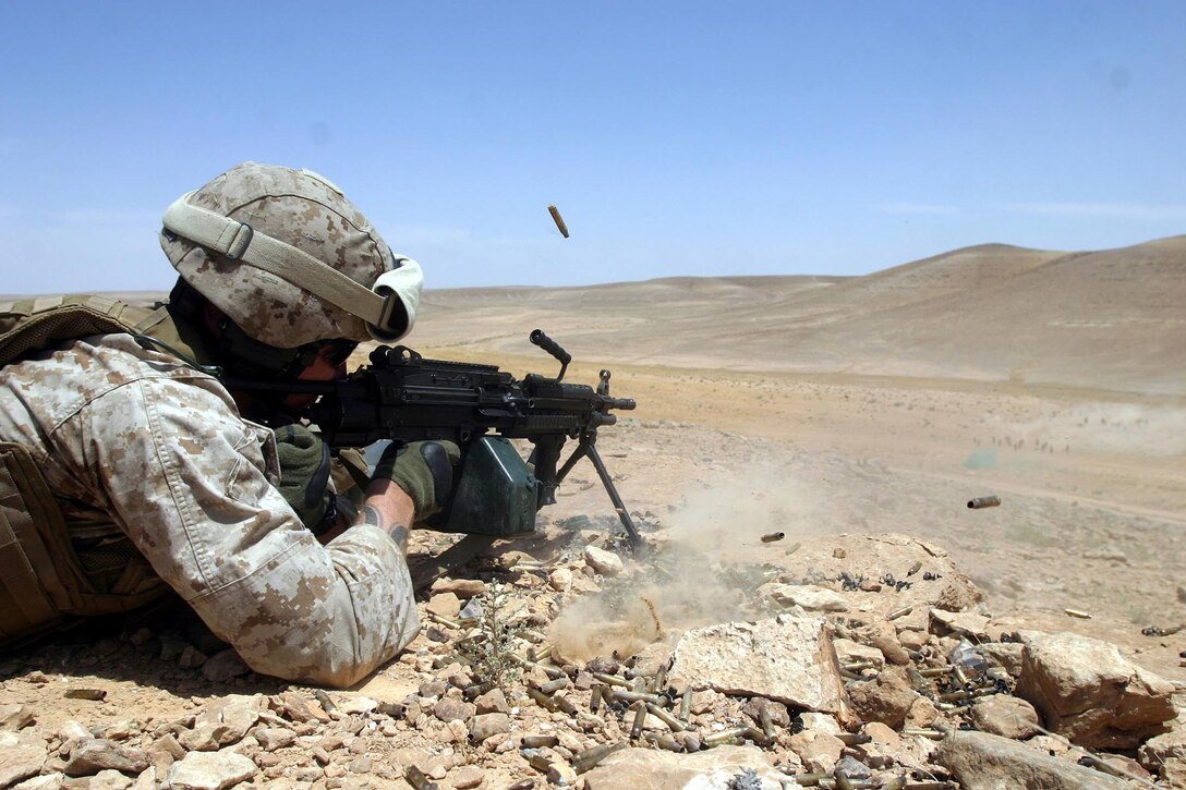 Sgt. Joseph P. Reiman, an automatic rifleman from Reconnaissance Platoon, Battalion Landing Team 2/2, 26th Marine Expeditionary Unit, spits out rounds with an M-249 Squad Automatic Weapon during an ambush at a range in the Middle East, May 25, 2007.  The Recon Plt. was conducting live-fire ambush training alongside regional forces.  (Official USMC photo by Cpl. Jeremy Ross) (Released)