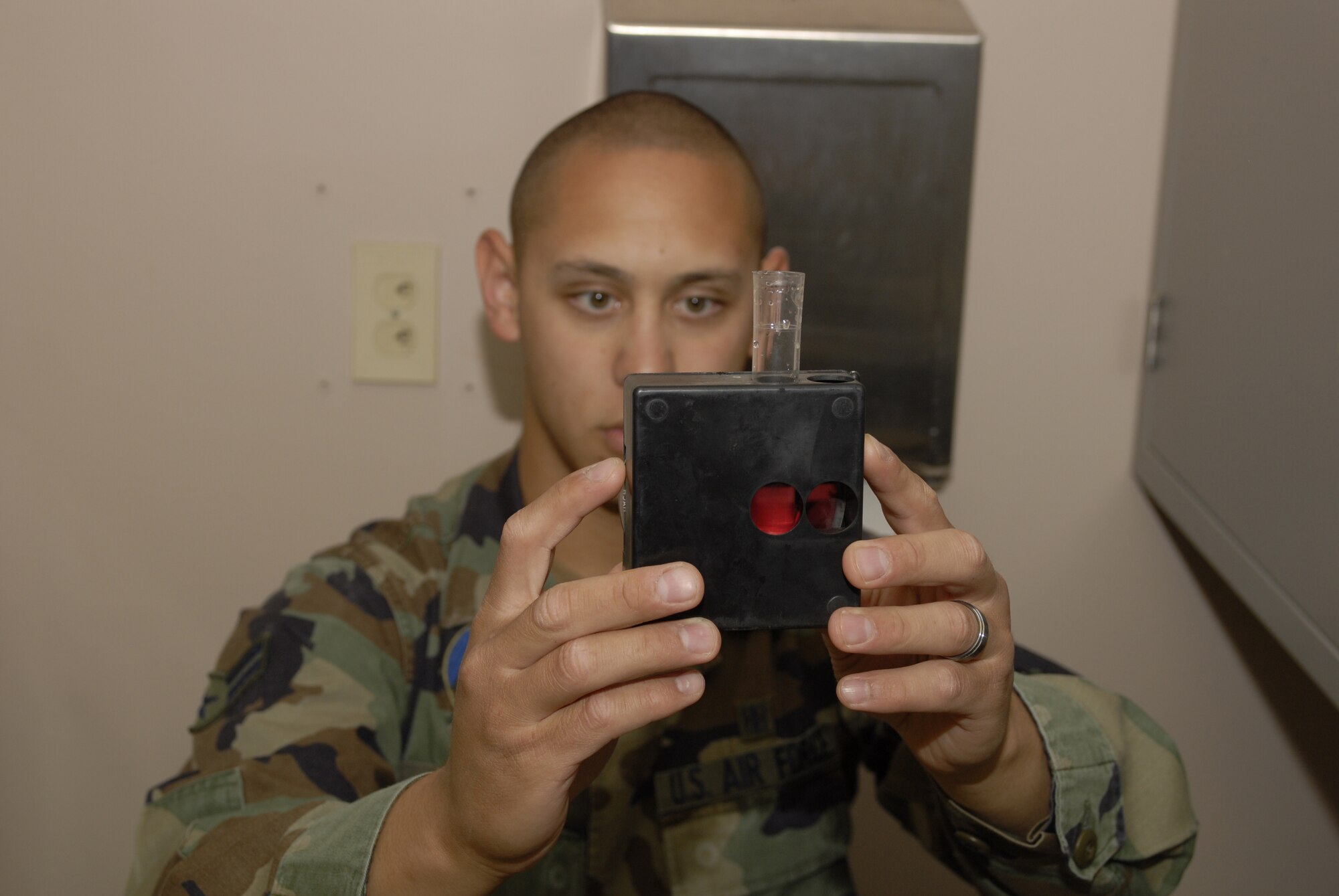 Airman 1st Class Michael Rivera, 56th Aerospace Medicine Squadron Bioenvironmental technician, conducts a bacteriological water sample test to ensure compliance with Arizona requirements for drinking water. (Photo by Staff Sgt. David Miller)