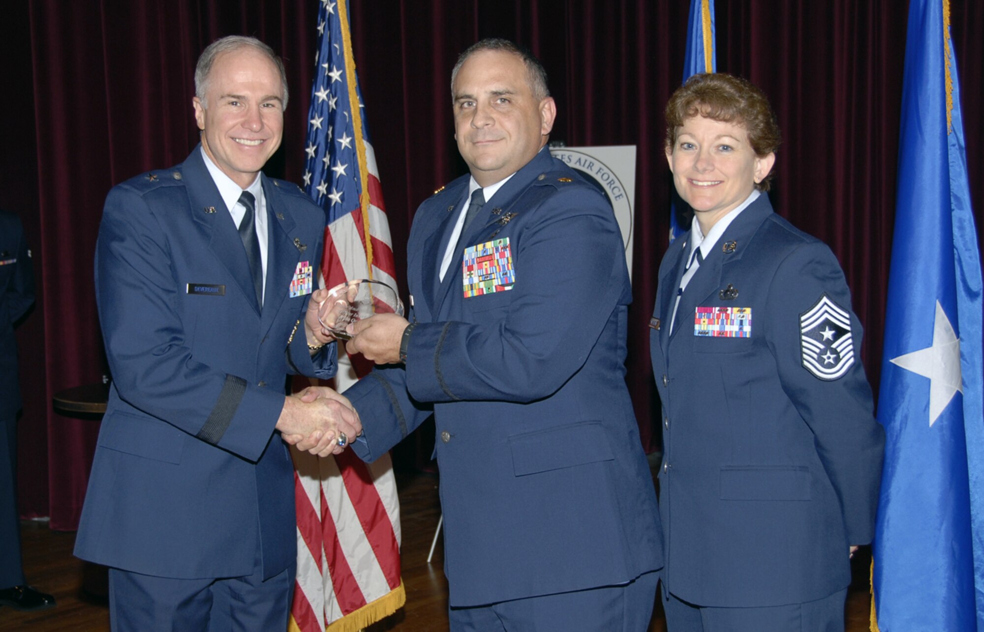 Maj. Andrew Reimund of the 381st Training Squadron receives his Officer Instructor of the Quarter award May 24 as part of the Quarterly Technical Training Awards ceremony in the base theater. Major Reimund identified 21 imminent computer failures associated with the Crisis Action Team and was key in the arrival of a new UH-60 Blackhawk medical readiness trainer. Also pictured is 82nd Training Wing Commander Brig. Gen. Richard Devereaux. (U.S. Air Force photo/Sandy Wassenmiller)