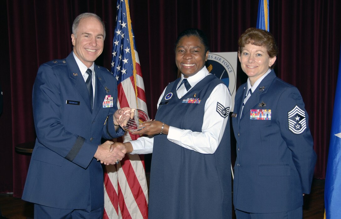 Staff Sgt. Christine Devito of the 383rd Training Squadron accepts the NCO Instructor of the Quarter aware May 24 during the Quarterly Technical Training Awards in the base theater. Sergeant Devito personally evaluated 399 medics and authored a 100-page medical lesson plan for the aerospace medical service apprentice course. She also earned her Community College of the Air Force degree. Also pictured is 82nd Training Wing Commander Brig. Gen. Richard Devereaux. (U.S. Air Force photo/Sandy Wassenmiller)