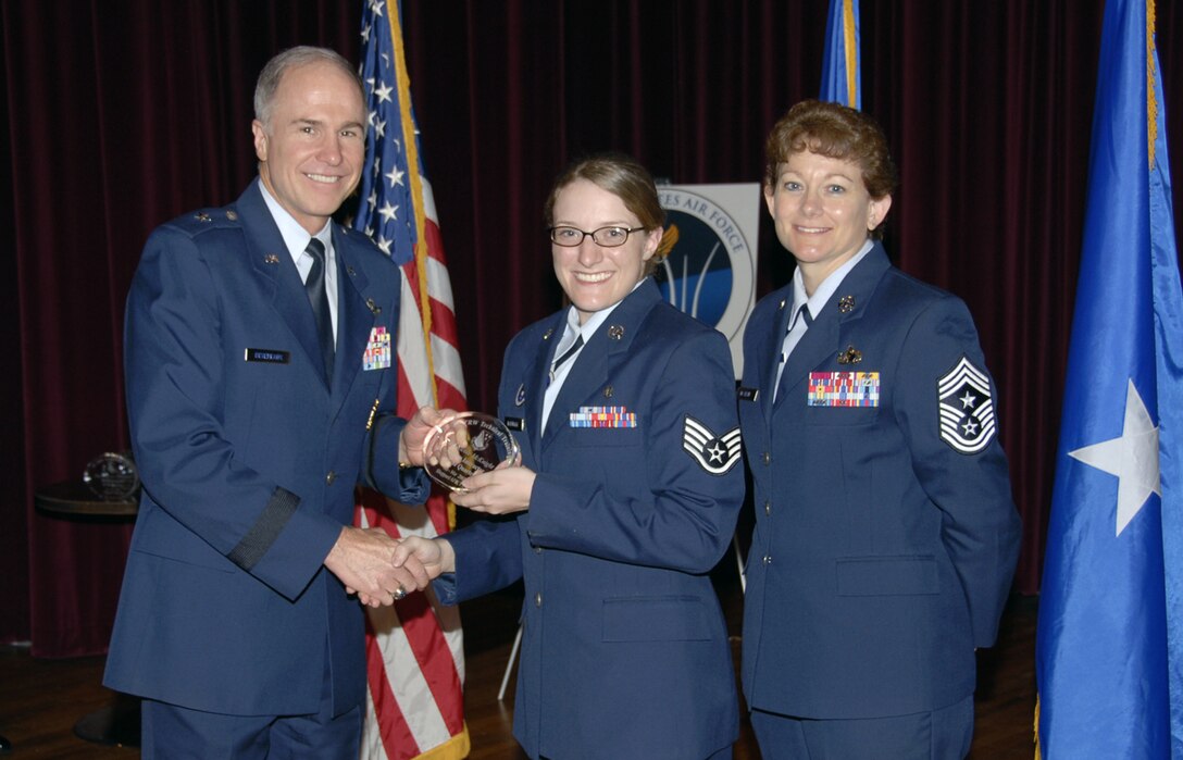 Staff Sgt. Nicole McKnight receives the Quarterly Technical Training Award for as the top Airman Instructor May 24 at the base theater. Sergeant McKnight, a member of the 381st Training Squadron's Medical Readines Flight, aided in the set up of the new Boeing 767 Civil Reserve Air Fleet trainer and also enhanced the realism of training for 625 medical personnel. She also completed her Community College of the Air Force degree. Also pictured is 82nd Training Wing Commander Brig. Gen. Richard Devereaux. (U.S. Air Force photo/Sandy Wassenmiller)