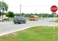 Vehicles rush through school zones on and near base, putting students at risk. Depending on the area, most school speed zones require motorists to slow to 20-25 mph when the amber lights are flashing. All motorists must obey directions by the crossing guard. "Many of our children attend schools near base, such as Valley Hi Elementary, Lackland City Elementary and Rayburn Middle Schools. It is our job to do everything possible to protect them. That means slowing down to the posted speed limit and listening to the crossing guards," said Brig. Gen. Darrell Jones, a former 37th Training Wing commander. "I would rather have our people show up two minutes later because they were watching out for our kids than have one of our young students injured due to impatience and careless driving." According to the City of San Antonio Municipal Court Web site, the fine for speeding in a school zone is $202 for the first 10 miles over the speed limit and $5 for each additional mile over. The fine for passing a stopped school bus is $638. (USAF photo by Alan Boedeker) 