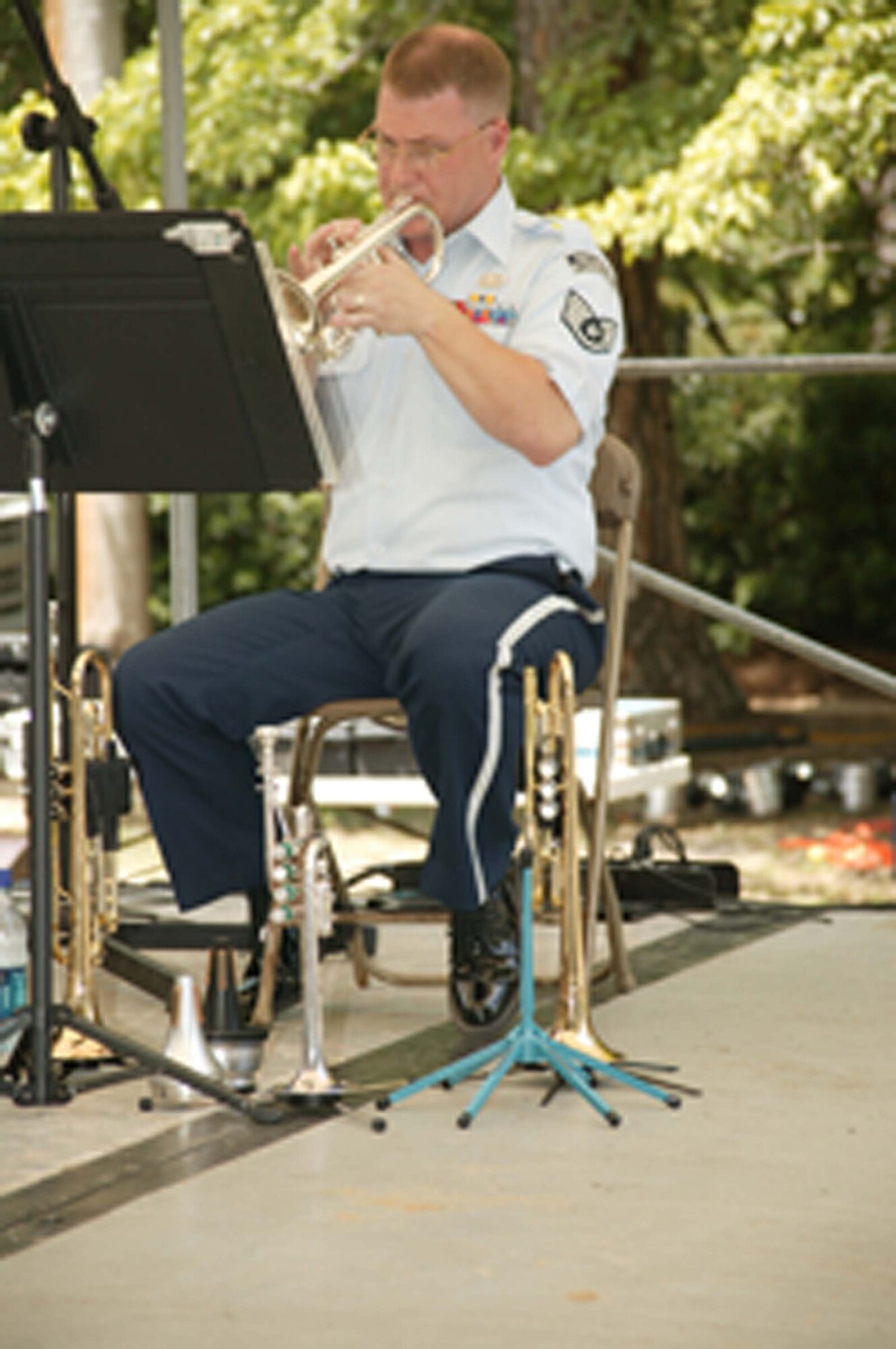 Sumter, S.C. -- Staff Sgt. Mark Nixon, U.S. Air Force Heritage of America Brass Quintet band member plays the trumpet at the Iris Festival May 25. The festival has been ranked among the top twenty festivals in the Southeast. This year marks sixty-seven years of the event and it draws thousands of people into the city of Sumter. Comprised of two trumpets, horn, trombone, and tuba, the quintet is part of the U.S. Air Force Heritage of America Band, a 60-member ensemble based at Langley Air Force Base, Va. The band played throughout the weekend and at the Sumter County Veterans Association Memorial Day Program on May 28.  (U.S. Air Force photo by Kimberly Champagne) 

