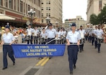 The 737th Training Group Drum & Bugle Corps, following Lackland's Band of the West in the Battle of Flowers Parade on April 27, 2007, passes the reviewing stand in Alamo Plaza. Drum Major Tech. Sgt. Ronald Gann salutes reviewing officials who included Brig. Gen. Darrell Jones, a former commander of the 37th Training Wing. Carrying the banner for U.S. Air Force Basic Military Training at Lackland AFB, Texas, are Trainees Sara Miller, left, and Alyssa Nazworth. Fiesta is an annual 10-day event with more than 100 scheduled events designed to honor the heroes of the Alamo and the Battle of San Jacinto. Lackland AFB, Texas, is represented in numerous events during the celebration, including the opening ceremonies, the Texas Cavaliers River Parade, the Battle of Flowers Parade, the Fiesta Flambeau night parade, Fiesta in Blue, the Air Force at the Alamo and the Fiesta Military Parade on base. (USAF photo by Alan Boedeker)                               