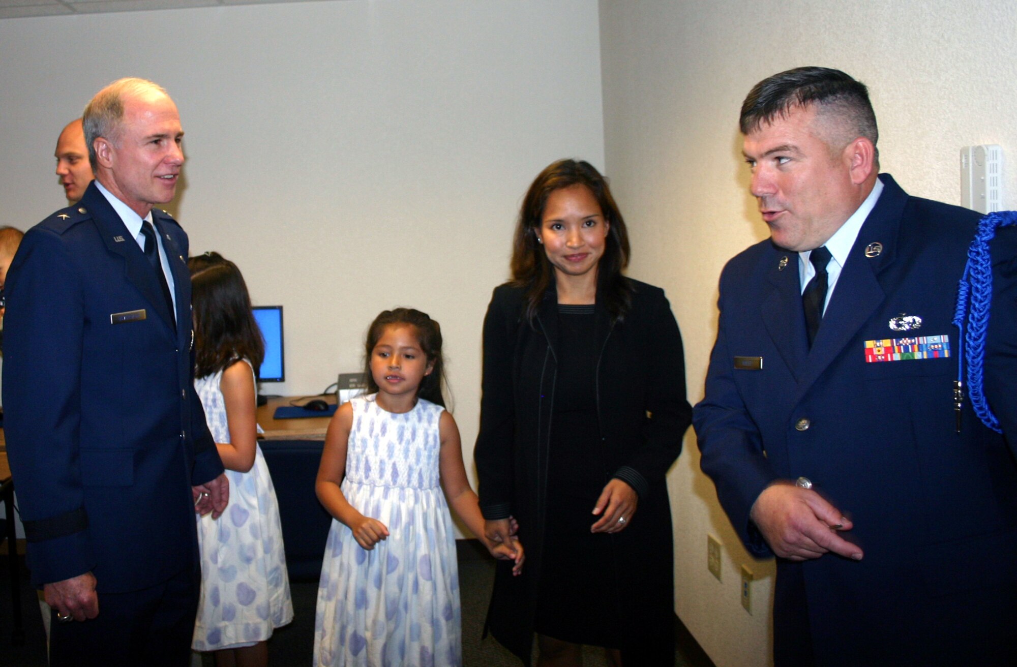 82nd Training Wing Commander Brig. Gen. Richard Devereaux, Hannah and Meghan Cunningham, and Theresa Cunningham-Miller are led on their tour of Cunningham Hall by Master Sgt. Chris Sheppard of the 366th Training Squadron at the dormitory's opening ceremony May 24. (U.S. Air Force photo/Staff Sgt. Tonnette Thompson)