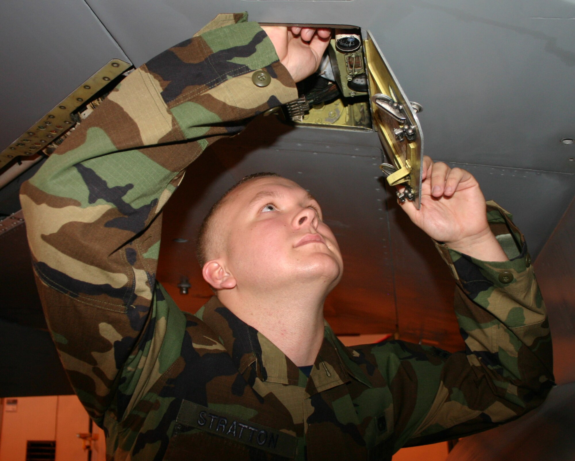 Airman 1st Class Derrick Stratton inspects an F-16 in Hangar 1040.  Airman Stratton, a student with the 362nd Training Squadron, was presented with the ACE award on May 25 for completing his F-16 Aircraft Maintenance Apprentice course with a 100 percent average. (U.S. Air Force photo/Staff Sgt. Tonnette Thompson)