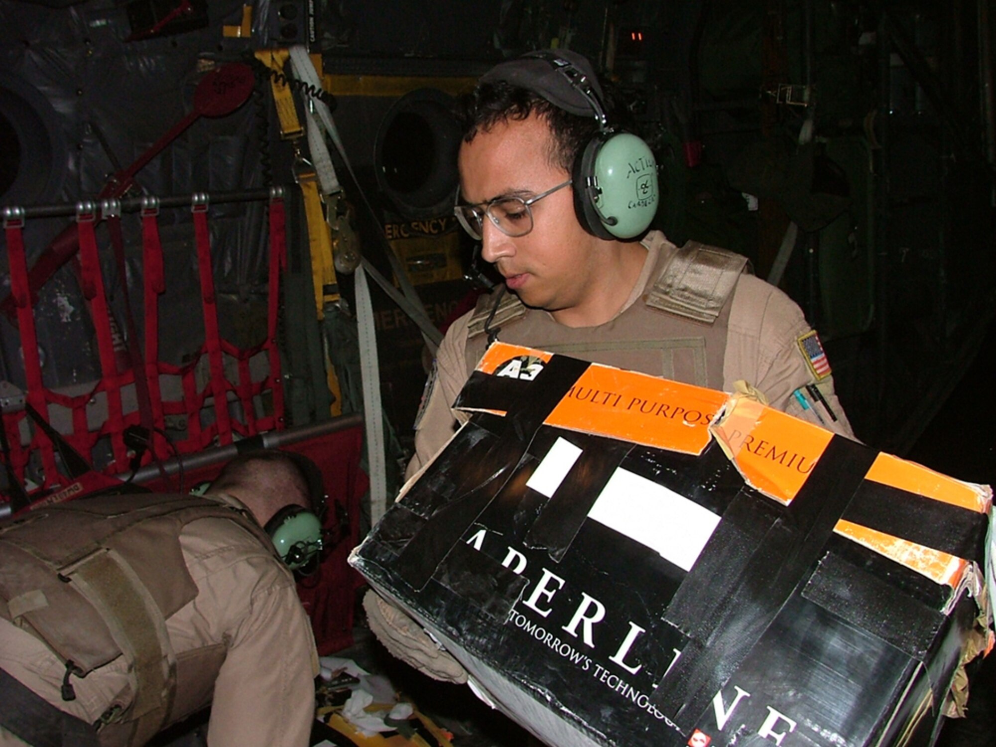 Airman 1st Class David Cardenas, 746th Expeditionary Airlift Squadron, positions a box of leaflets. Airman Cardenas dropped more than 80,000 leaflets over Afghanistan in support of Operation Enduring Freedom. 