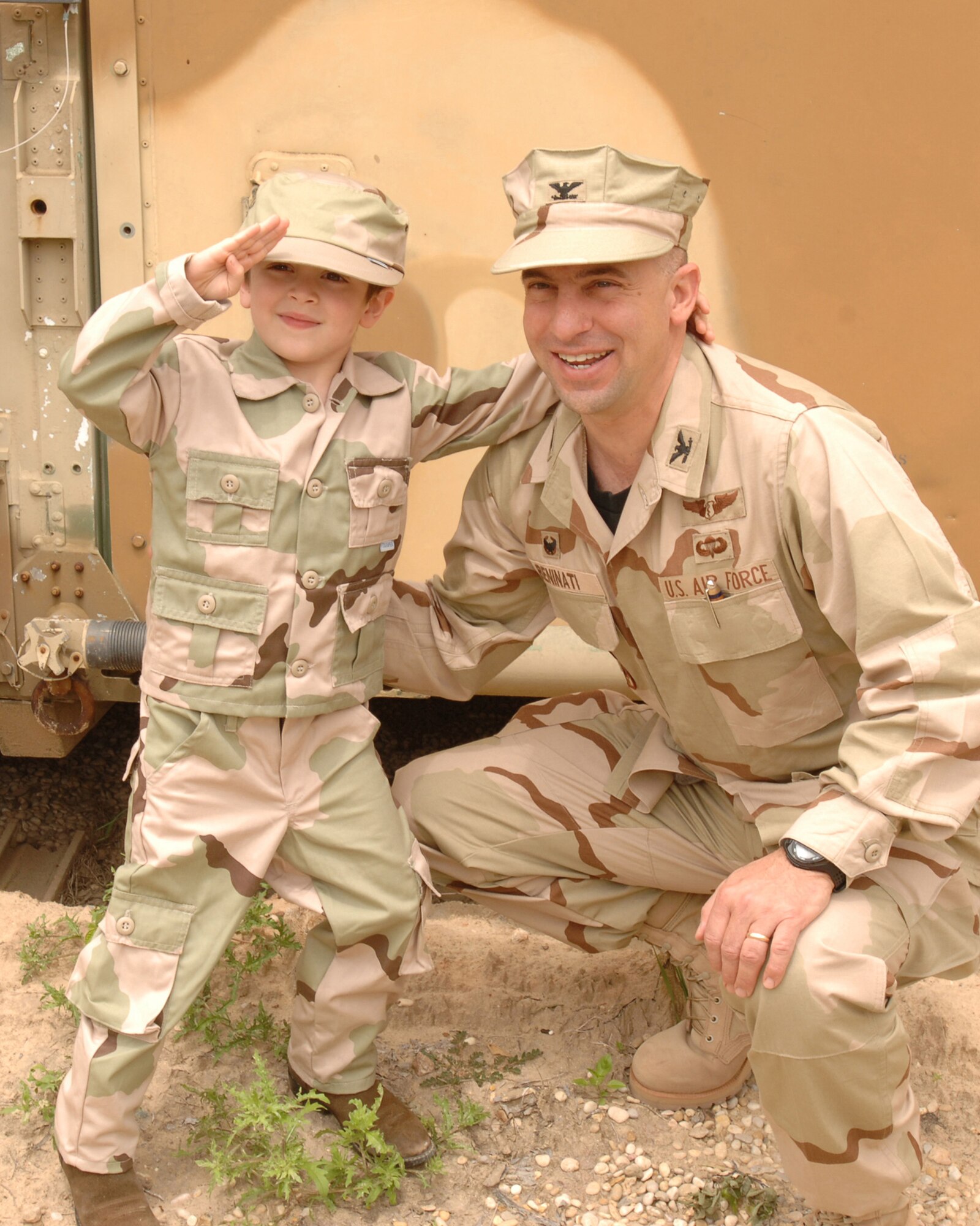Col. (Dr.) William Beninati, 59th Surgical Operations Group commander, poses with his son at the 59th Medical Wing's Deployers Picnic held at Camp Rissington on Lackland Air Force Base, Texas, in April. The event paid tribute to the wing's Air Expeditionary Force cycle seven and eight deployers who are now departing world-wide. (U.S. Air Force photo Tech. Sgt. Thomas Coney)