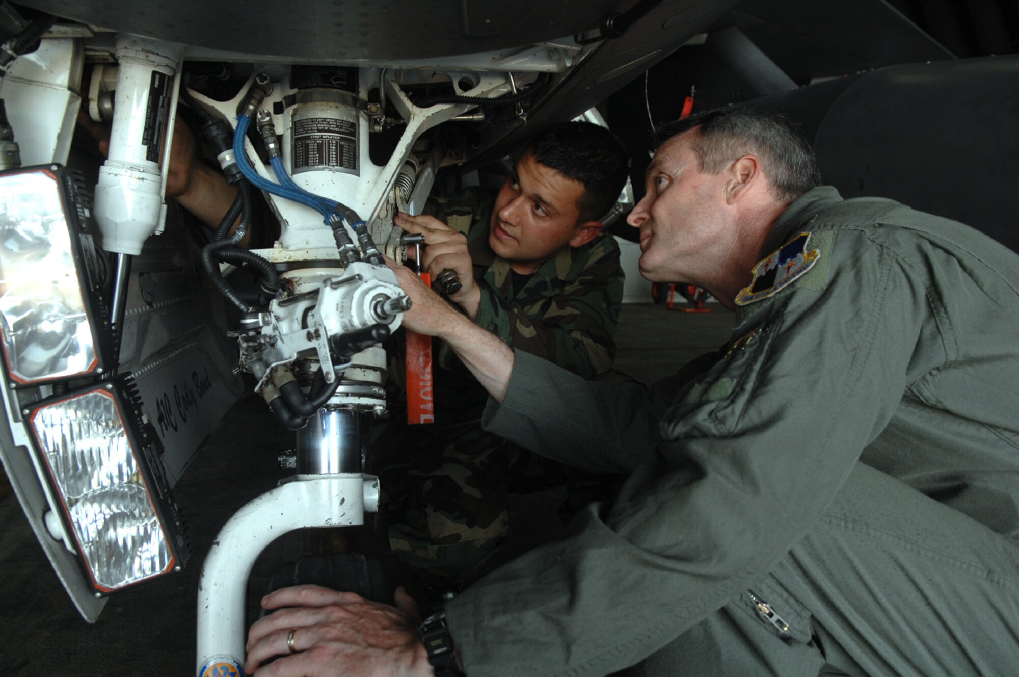 SPANGDAHLEM AIR BASE, GERMANY -- Col. Darryl Roberson, 52nd Fighter Wing commander, checks F-16 landing gear with Airman Jeff Kakaley, 52nd Aircraft Maintenance Squadron, May 21. Airman Kakaley, a Harleigh, Pa., native, is an assistant dedicated crew chief who has been in the Air Force for one year. Airman Kakaley’s supervisor, Senior Airman Joshua Teakles, said, “Airman Kakaley is a highly motivated Airman who has excelled at being an F-16 crew chief. He is a quick learner who shows great potential to go far and do great things in the U.S. Air Force.” Airman Kakaley’s personal goals are to finish a teaching degree and score a 95 percent or better on his Career Development Course exam. (US Air Force photo/Senior Airman Josie Kemp)